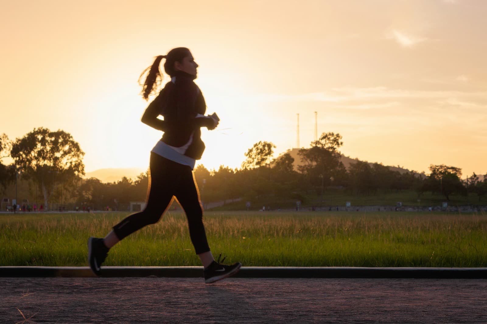 A runner on a track at golden hour